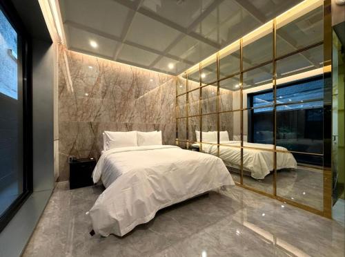 a bedroom with two beds and a large window at 델루나호텔 부평점 in Incheon