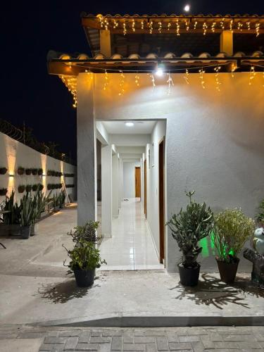 a hallway of a building with potted plants and lights at Pousada Flor do Sol in Fortaleza