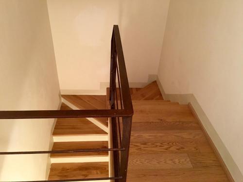 a staircase in a room with wooden floors at Locanda Palazzone in Orvieto