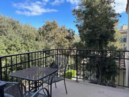 a table and chairs on a balcony with a fence at Tranquil Terrace in Oceano