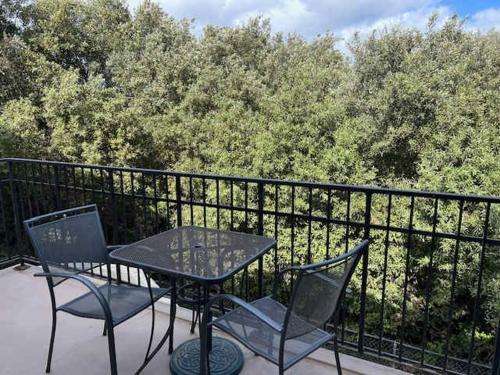 a table and chairs on a balcony with a fence at Tranquil Terrace in Oceano