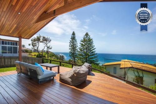 a deck with a view of the ocean on a house at Seaview I Pet Friendly with Stunning Views I 1 Min to Beach in Culburra Beach
