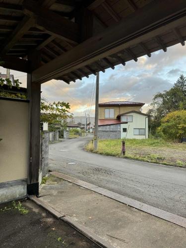 an empty street with a building on the side of the road at Hygge KAWATABI in Osaki
