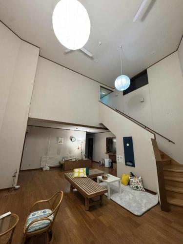 a living room with a couch and a table at Hygge KAWATABI in Osaki