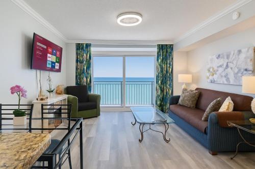 a living room with a couch and a table at Paradise Resort in Myrtle Beach