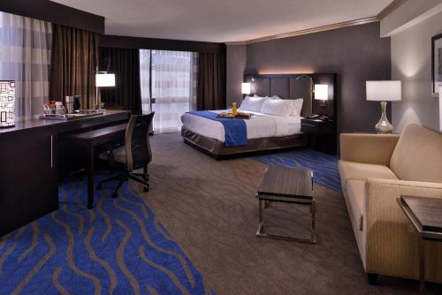 a hotel room with a bed and a desk at Radisson Hotel St Louis Downtown Convention Center in Saint Louis