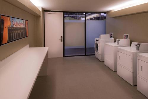 a laundry room with a washer and dryer at Radisson Hotel St Louis Downtown Convention Center in Saint Louis