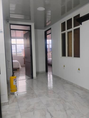 a living room with a yellow fire hydrant on the floor at Hotel Iraca in Aquitania