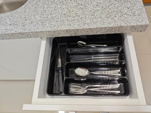 a drawer in a counter with utensils in it at Habitacion con entrada independiente y aire acondicionado, Centro Piura in Piura