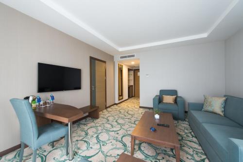 a living room with a couch and a table at Radisson Blu Hotel, Ordu in Ordu