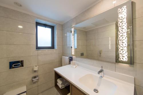 a bathroom with a sink and a mirror at Radisson Blu Hotel, Ordu in Ordu