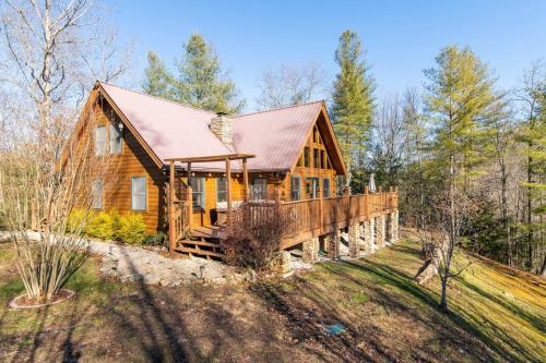 a log cabin in the woods with a roof at Hot Tub - Mill Creek Point - Red River Gorge KY in Rogers