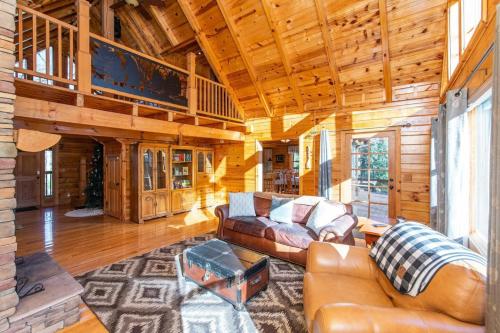 a living room with a couch and a table at Hot Tub - Mill Creek Point - Red River Gorge KY in Rogers