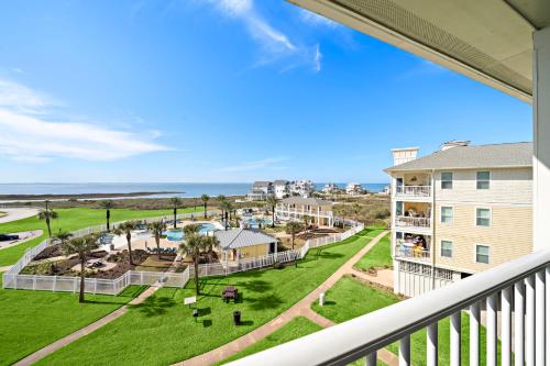 a balcony with a view of the beach and buildings at Pointe West 302 - Sunset on the Bay in Galveston