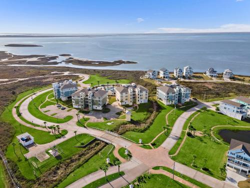 an aerial view of an apartment complex next to the ocean at Pointe West 302 - Sunset on the Bay in Galveston