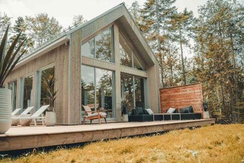 a house with windows and chairs on a deck at Zen House 7 - Villas & Spa in Morin Heights