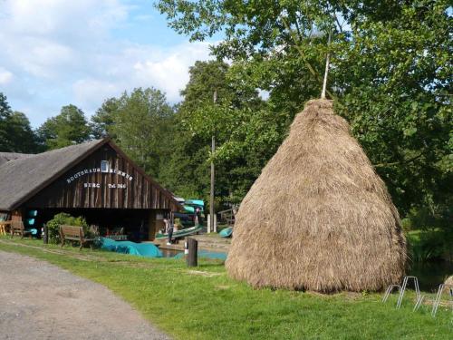a pile of hay in front of a barn at Apartments in Vetschau Spreewald 2618 in Vetschau