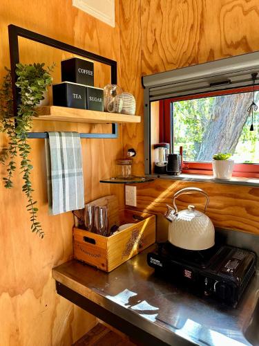 a kitchen with a counter top with a window at Waiata Shepherds Hut- Off Grid retreat in Hanmer Springs