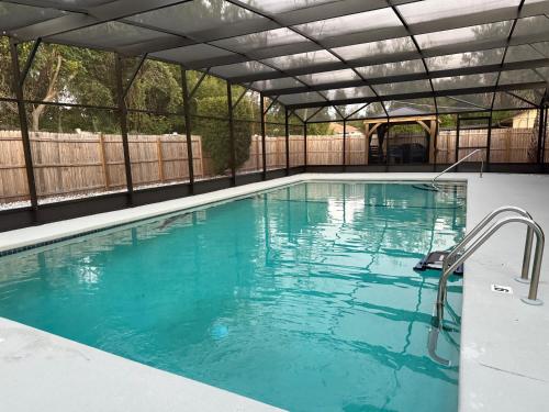 a large swimming pool with a retractable roof at Serene Sunshine State Escape in Deltona