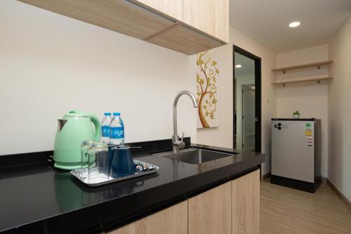 a kitchen with a sink and a refrigerator at iCheck inn Darisa Patong in Patong Beach