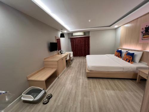 a bedroom with a bed and a sink and a tub at Curve Boutique Hotel in Pattaya Central
