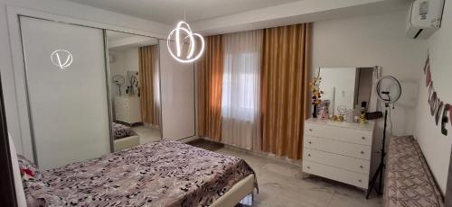 a bedroom with a bed and a mirror and a dresser at Modern & Comfortable Apartment in Aouina in El Aouina Station