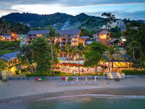 a view of a resort from the beach at night at Thai Fight Hotel in Lamai