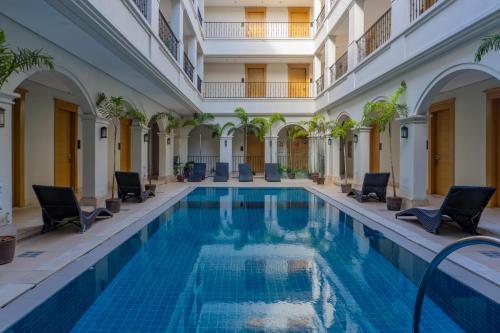 a swimming pool in a building with chairs around it at Boracay Sands Hotel in Boracay