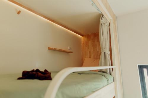 a bunk bed in a room with a window at Ark Guesthouse in Pai