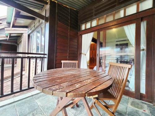 a wooden table and two chairs on a porch at Sea Villa Langkawi in Kampung Padang Masirat