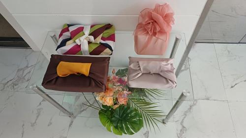 three bags on a glass table with a plant at Yeon Stay in Seoul