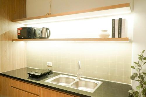 a kitchen counter with a sink and a microwave at Whole House with 3 Bedrooms in Hoan Kiem - 7mins to Hoan Kiem lake - FREE launchdry & breakfast in Hanoi