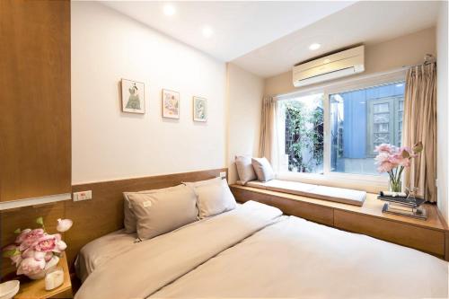 a bedroom with a bed and a window at Whole House with 3 Bedrooms in Hoan Kiem - 7mins to Hoan Kiem lake - FREE launchdry & breakfast in Hanoi
