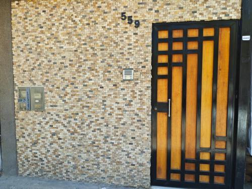 a door to a brick building with a brick wall at Habitacion con entrada independiente y aire acondicionado, Centro Piura in Piura