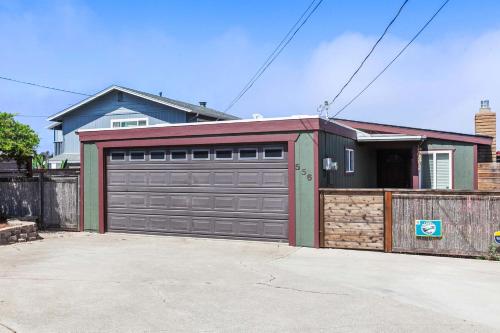 a garage door with a fence and a house at The Bay Escape in Cuesta-by-the-Sea