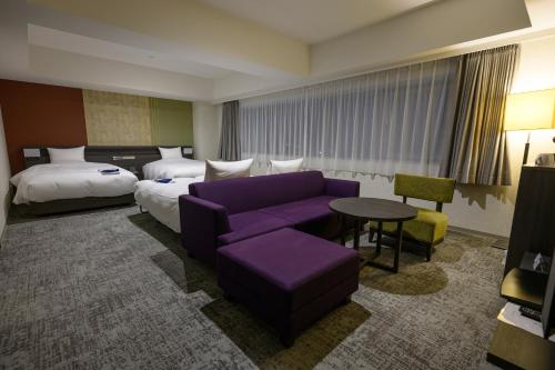 Ένα ή περισσότερα κρεβάτια σε δωμάτιο στο Hotel Kanazawa