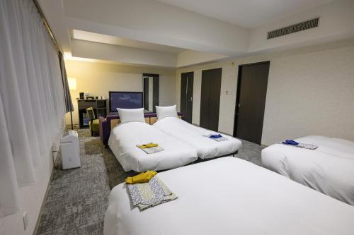 Ένα ή περισσότερα κρεβάτια σε δωμάτιο στο Hotel Kanazawa
