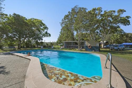 a swimming pool at a park with a person in it at Reflections Mylestom - Holiday Park in Mylestom