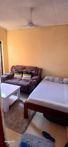 a living room with a couch at Smooth Landing in Ukunda