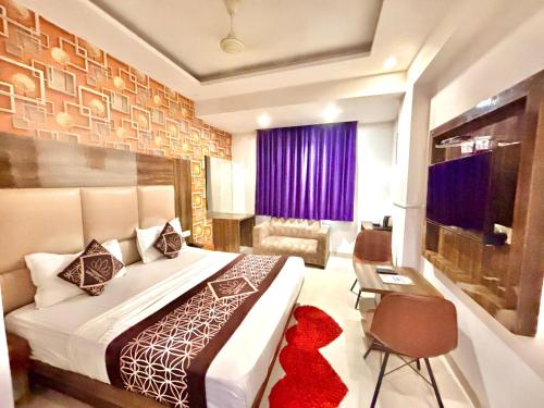 a bedroom with a large bed and a purple window at Hotel Premium Suites Near Delhi Airport in New Delhi