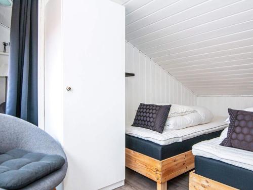 a room with a bed and a couch and a chair at 4 person holiday home on a holiday park in Hemmet in Hemmet