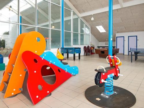 a play room with a playground with a slide at 4 person holiday home on a holiday park in Hemmet in Hemmet