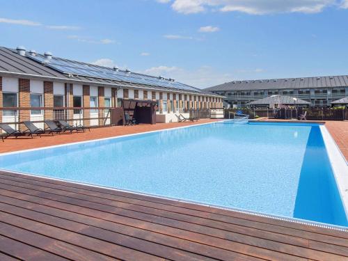 a large swimming pool on the roof of a building at Apartment with terrace in a holiday park in Fanø