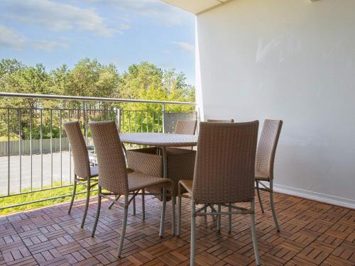 a porch with a table and chairs on a balcony at Holiday home on a holiday park in Glesborg in Glesborg