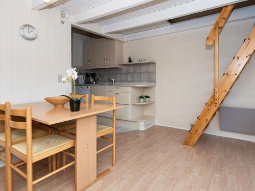 a kitchen and dining room with a table and chairs at 6 person holiday home on a holiday park in Hemmet in Hemmet