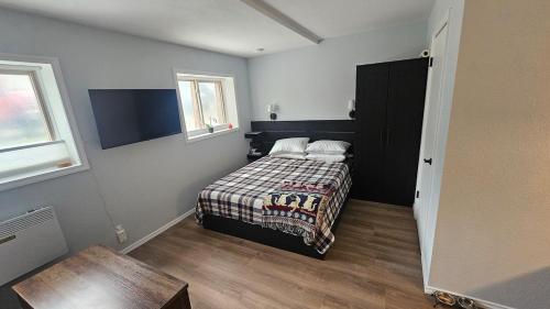 a small bedroom with a bed and a window at Mt Spokane ski condo in Mead