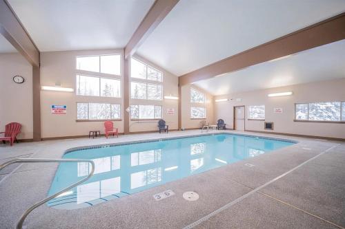 a large swimming pool in a large room with windows at Mt Spokane ski condo in Mead