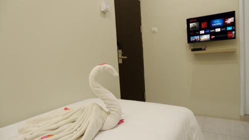 a swan made out of towels sitting on a bed at The One Residence Tanah Abang in Jakarta