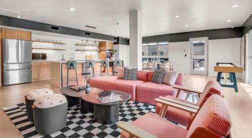 a living room with a pink couch and a kitchen at Luxury Central City Escape in Salt Lake City