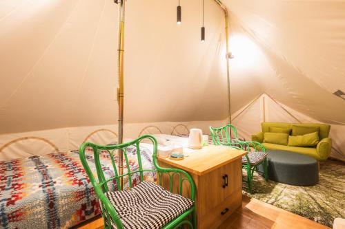 a room with a bed and chairs in a tent at SPRINGS VILLAGE Ashigara Tanzawa Onsen Resort & Gl - Vacation STAY 41906v in Hata